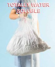hospital worker holding full water soluble laundry bag