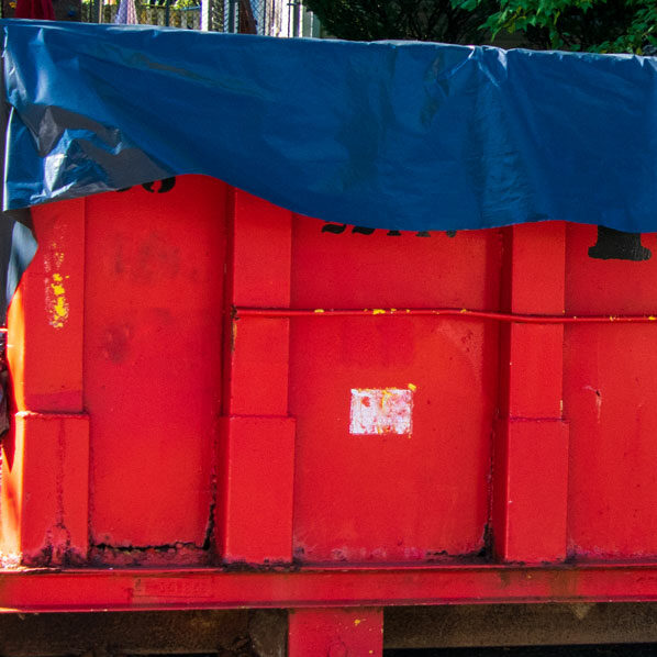 dumpster liner shown on red dumpster