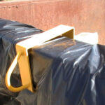 metal anchor/clip holding dumpster in place