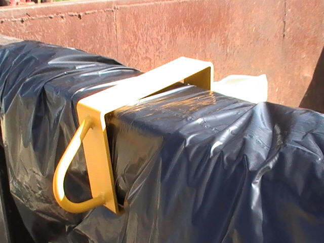 metal anchor/clip holding dumpster in place