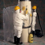 asbestos glovebags being used by 2 workers