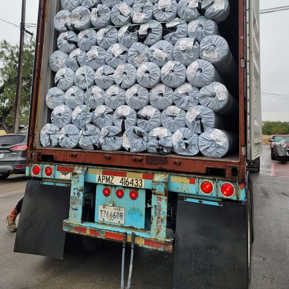 rolls of materials arriving by truck